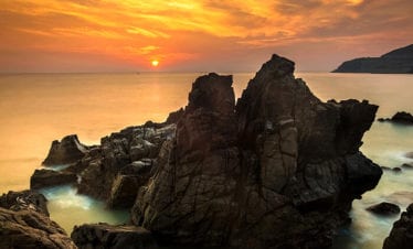 nature-seascape-with-exotic-boulders-silky-water-at-gorgeous-orange-sunrise-Nha Trang-Vietnam