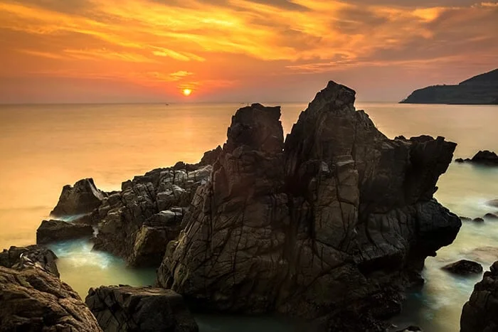 nature-seascape-with-exotic-boulders-silky-water-at-gorgeous-orange-sunrise-Nha Trang-Vietnam