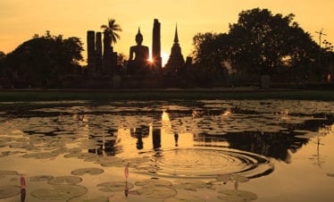 silhouette-of-ancient-buddha-statue-and-pagodas-against-sunset-sky-at-sukhothai-thailand-(sukothai)