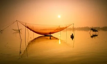 unidentified-fisherman-checks-his-nets-in-early-morning-on-river-in-hoian-vietnam-hoi an