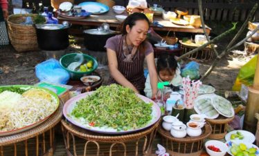 Asian lady making traditional food